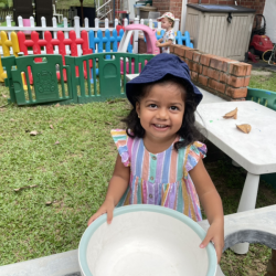 Savhara playing in the outside kitchen.