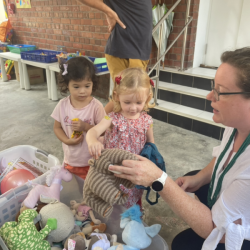 Charlotte and Isla picking out things from the book and toy sale.