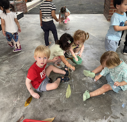 Drawing with chalk during outside time.