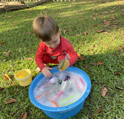 Skyler using the sponges and scrubbers during splash time.
