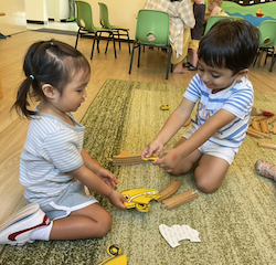 Allie and  Kathavya working on a puzzle together.