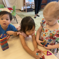 Avery, Allie and Isabelle are building with magna tiles.