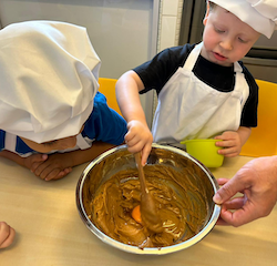 George was helping his daddy stir the cookie mixture.