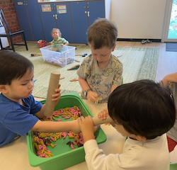 Having fun playing with the sensory bin.