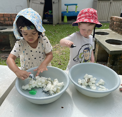 Playing with “ice” and “snow.” Did it feel cold, George and Leela?