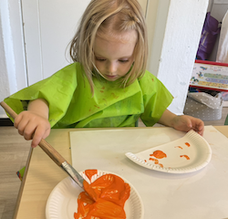 Poppy working on her transportation art.