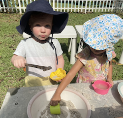 Thomas and Leela making a special creation in the mud kitchen.
