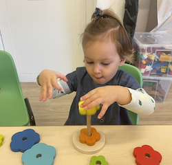 Victoire putting together the flower puzzle.