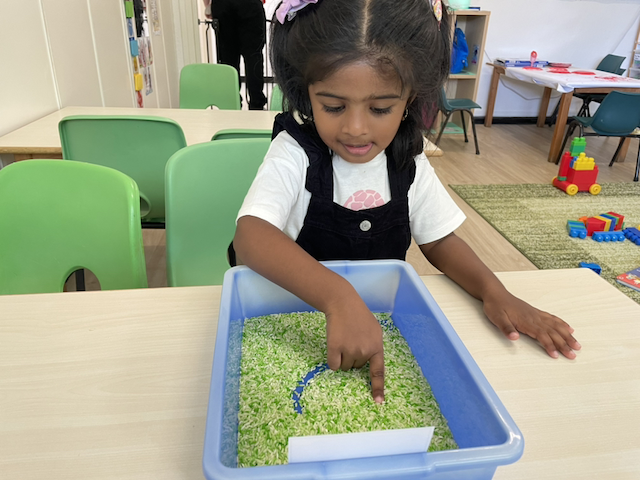 Kaavya practising letter tracing