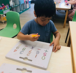 Isaac works on his number formation!