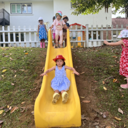 Eden enjoying sliding down the slide. 