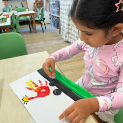 Kainaat completing her handprint fire truck. 