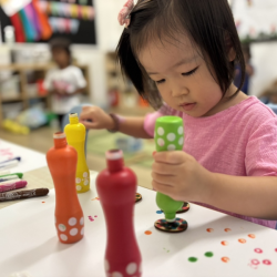 Constance doing dot stamping on Easter ornaments!