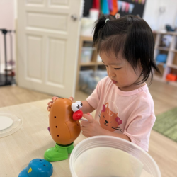 Constance having a go with Mr Potato!