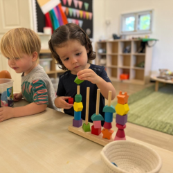 Cru slotting beads through the rods!