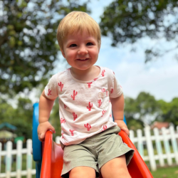 A big smile from Finlay on the top of the slide!