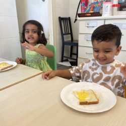 Imaan and Kavi are enjoying their Egg-in-a-Hole!