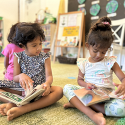 Two friends reading together.