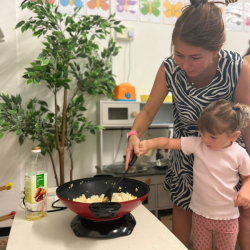 🍳✨ Mixing it up like a pro — Immy gives the scrambled eggs a good stir into the rice. Yum!