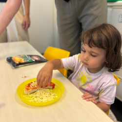 A sprinkle of cheese magic! Laleh’s pizza is almost too good to share!