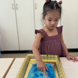 Harper getting mesmerised by a lava lamp in a bag—science meets squishy fun!