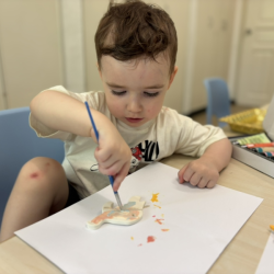 Liam painting his turtle, Tiny Tim!