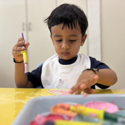 Mix, swirl, and wonder — Shriyan discovers the magic of pink and orange!