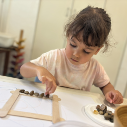 Total focus from Laleh as she carefully places pebbles and stones