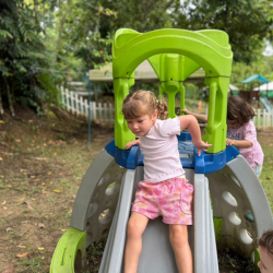 Wheee! Immy takes the fast lane down the slide!