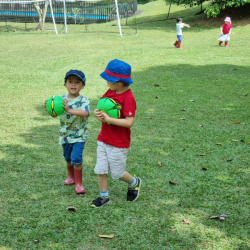 Ei and Trevor enjoying outdoors with frisbee balls .