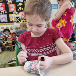 Esme decorating her friendship pot beautifully, just like always.