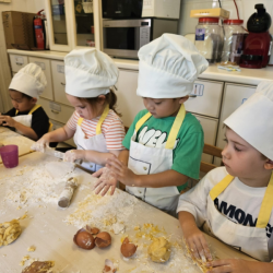 Busy bees enjoying getting messy with pasta making .