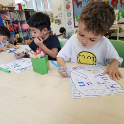 Finley and Lorenzo putting their creative skills on paper.