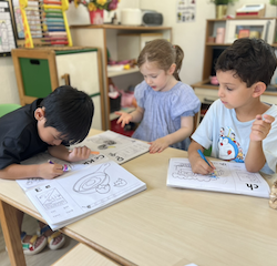 Lorenzo, Esme and Luca doing a great job with their sound book .