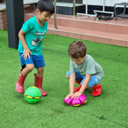 Lorenzo and Finley experimenting with the frisbee magic balls .