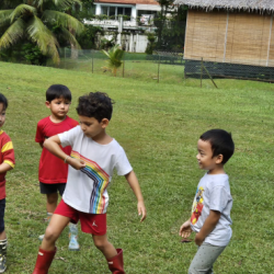 Luca teaching his friends the correct technique of using a frisbie.