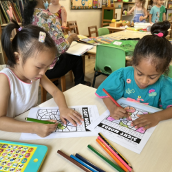 Lucy and Reina concentrating on their sight word activity .