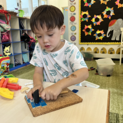 Trevor building a blue house.