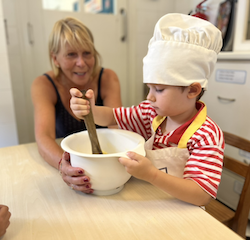 Wilbur applying all his muscle strength to mix the mixture.