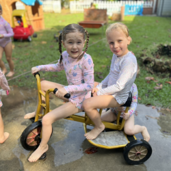 Esme and Regan having a dashing splash time .