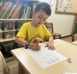 Finley practicing his reading and writing.