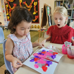 Myla working on her colourful art work.