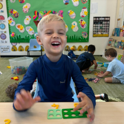 Rowan having fun with mathematics counters.