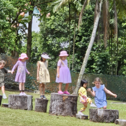 The girls having fun balancing on the logs.