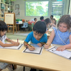 Toria, Enzo and Paige enjoying word finding puzzle.