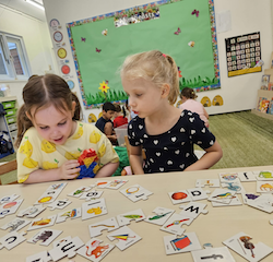 Vivi and Regan completing the alphabet puzzle together.