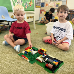 Wilbur and Rowan proudly showing what they build with Lego .