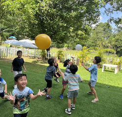 Busy Bees having fun keeping the balloons up .