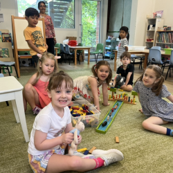 Busy bees having fun building with wooden blocks. 