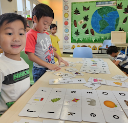 Lincoln and Ei matching and practicing letter sounds.